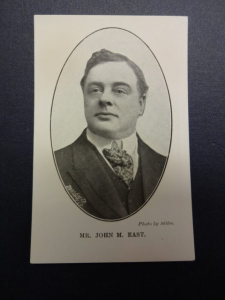 John M East