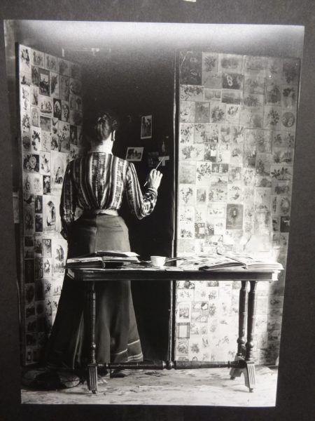 View of a lady pasting photographs