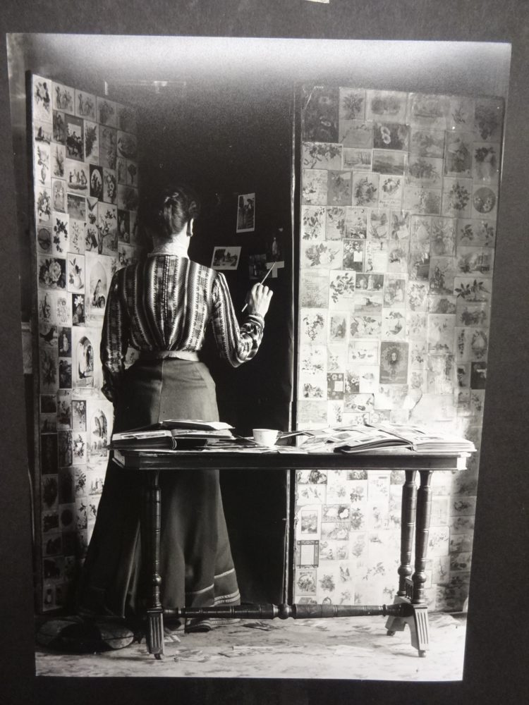 View of a lady pasting photographs