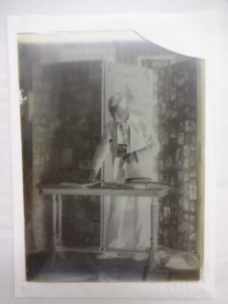 Dr Baker looking through photograph albums