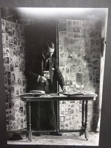 Dr Baker looking through photograph albums