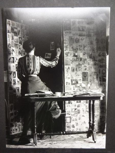 Unidentified lady assembling photographs on a screen