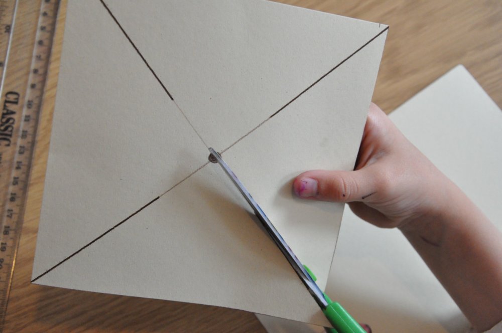 Scissors cutting the square shape out.