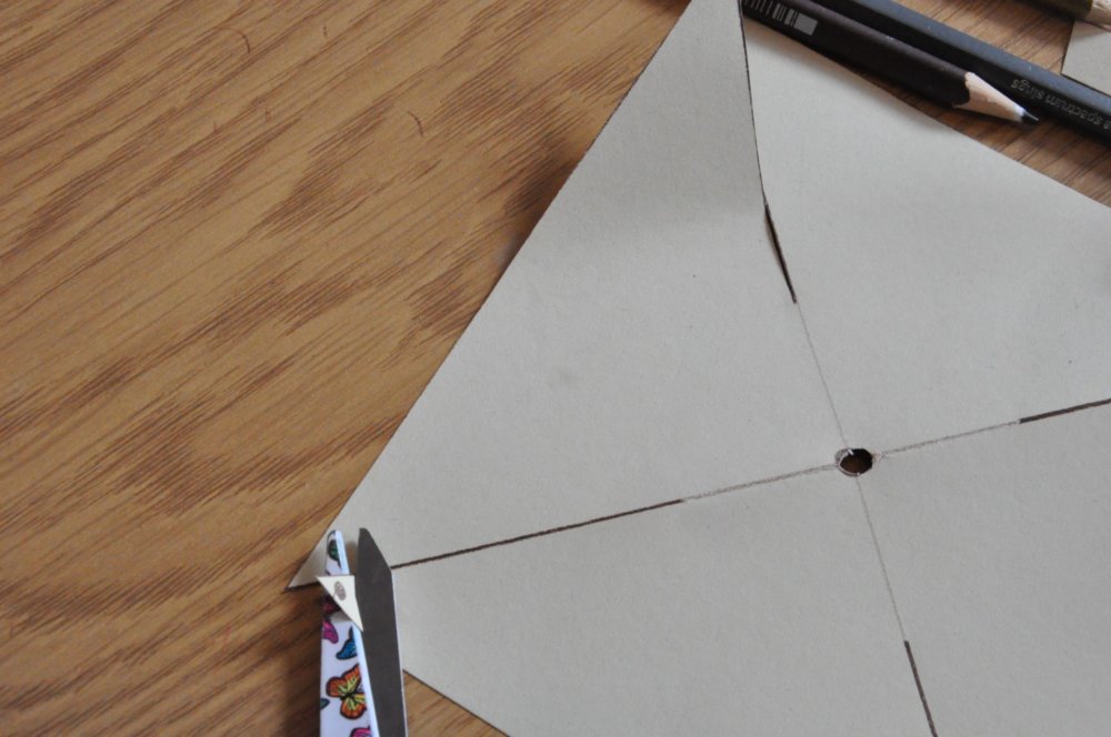 Scissors cutting small dots from the square.