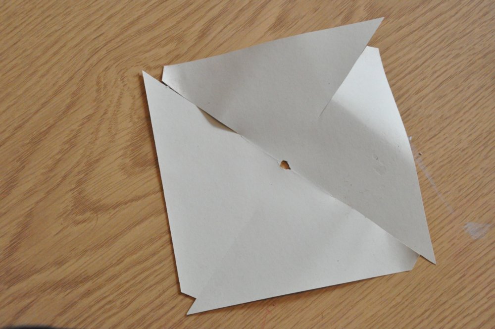 The final template square, with a hole in the middle, slits from each corner and some edges removed.