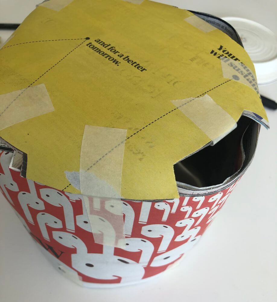 The newspaper as a cylinder, attached with tape