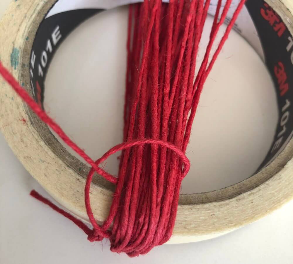 Masking tape wrapped with sting and tied at the end.