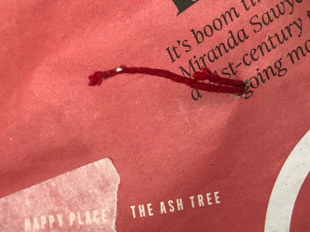 String poking through the newspaper
