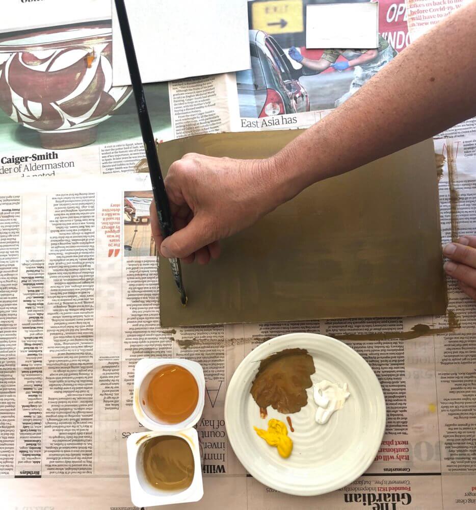 A cardboard rectangle being painted